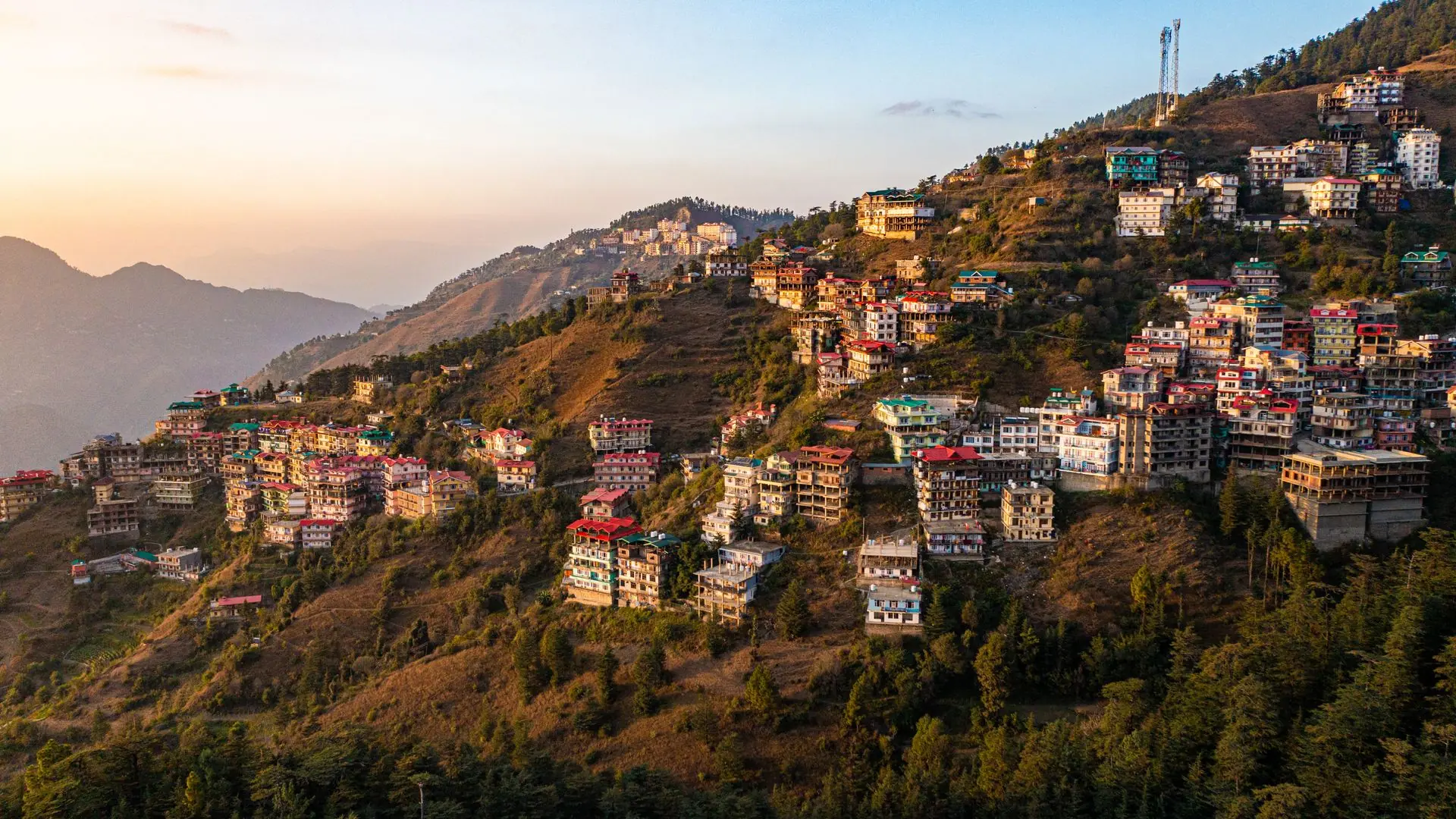 Aerial view of colorful buildings on Shimla hills during sunrise in Himachal Pradesh, India