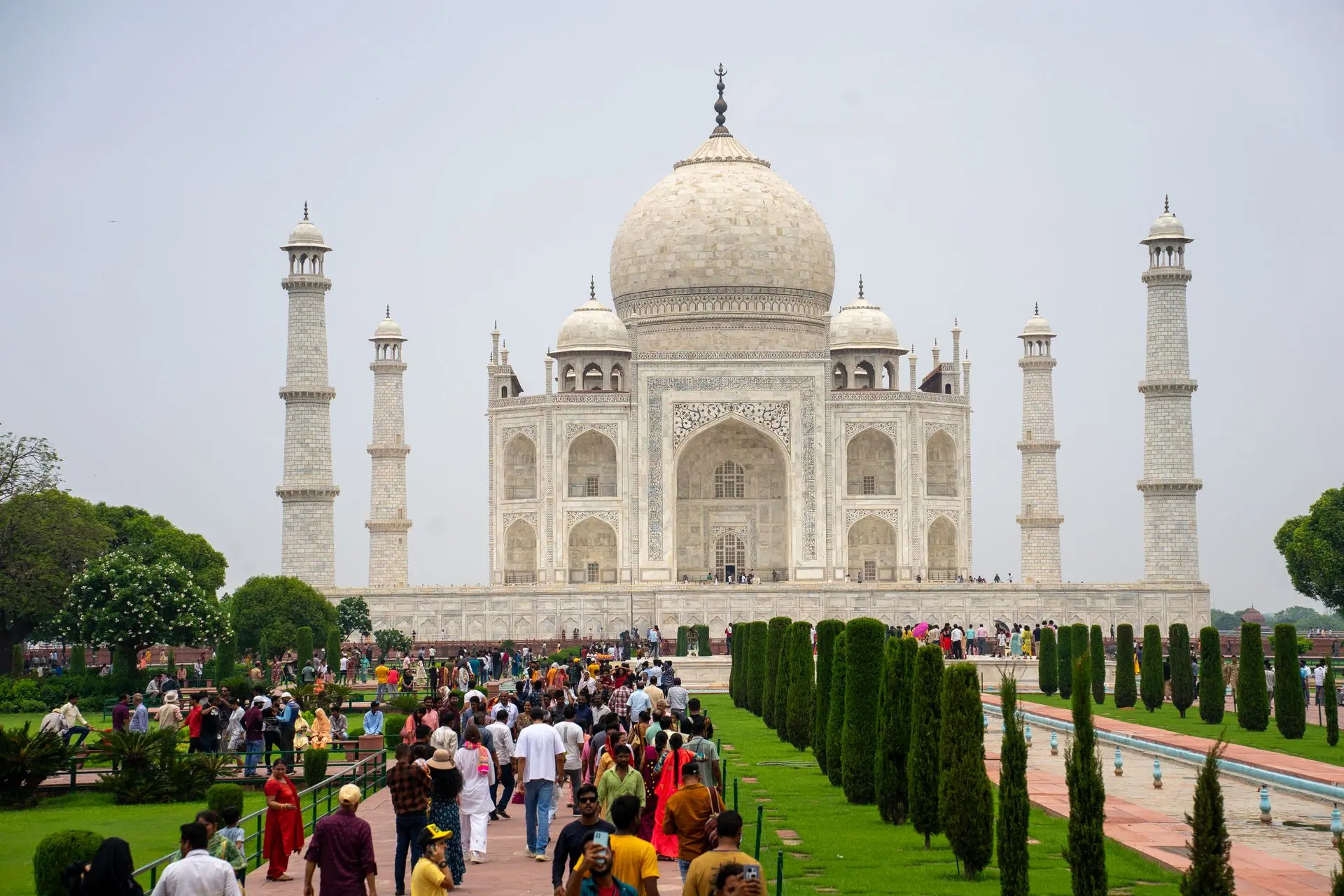 Iconic Taj Mahal in Agra, India bustling with tourists on a bright day