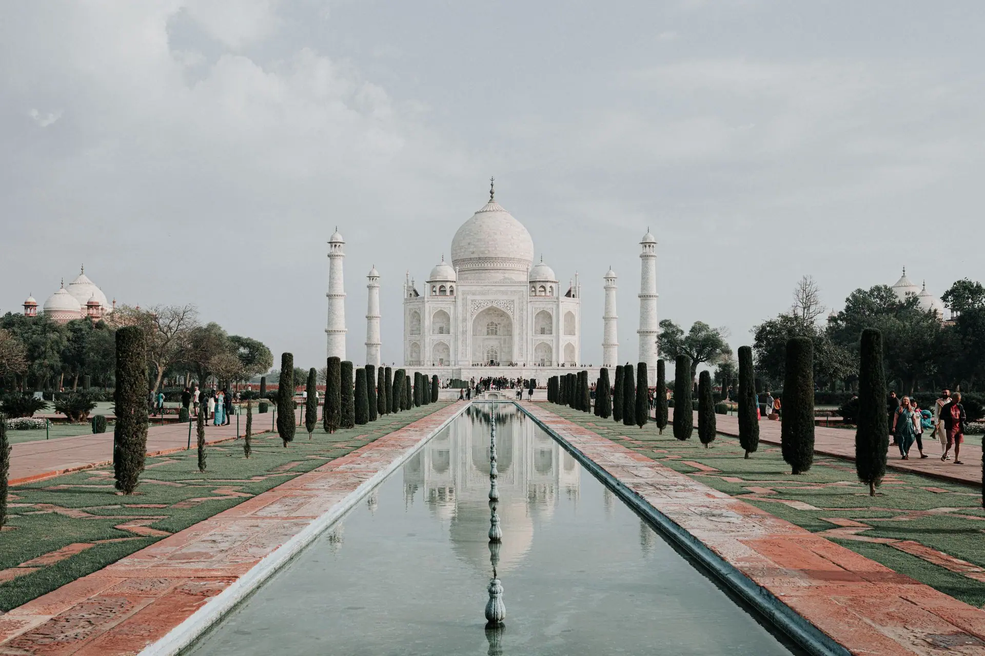 A serene and captivating perspective of the iconic Taj Mahal in Agra with reflection in pool