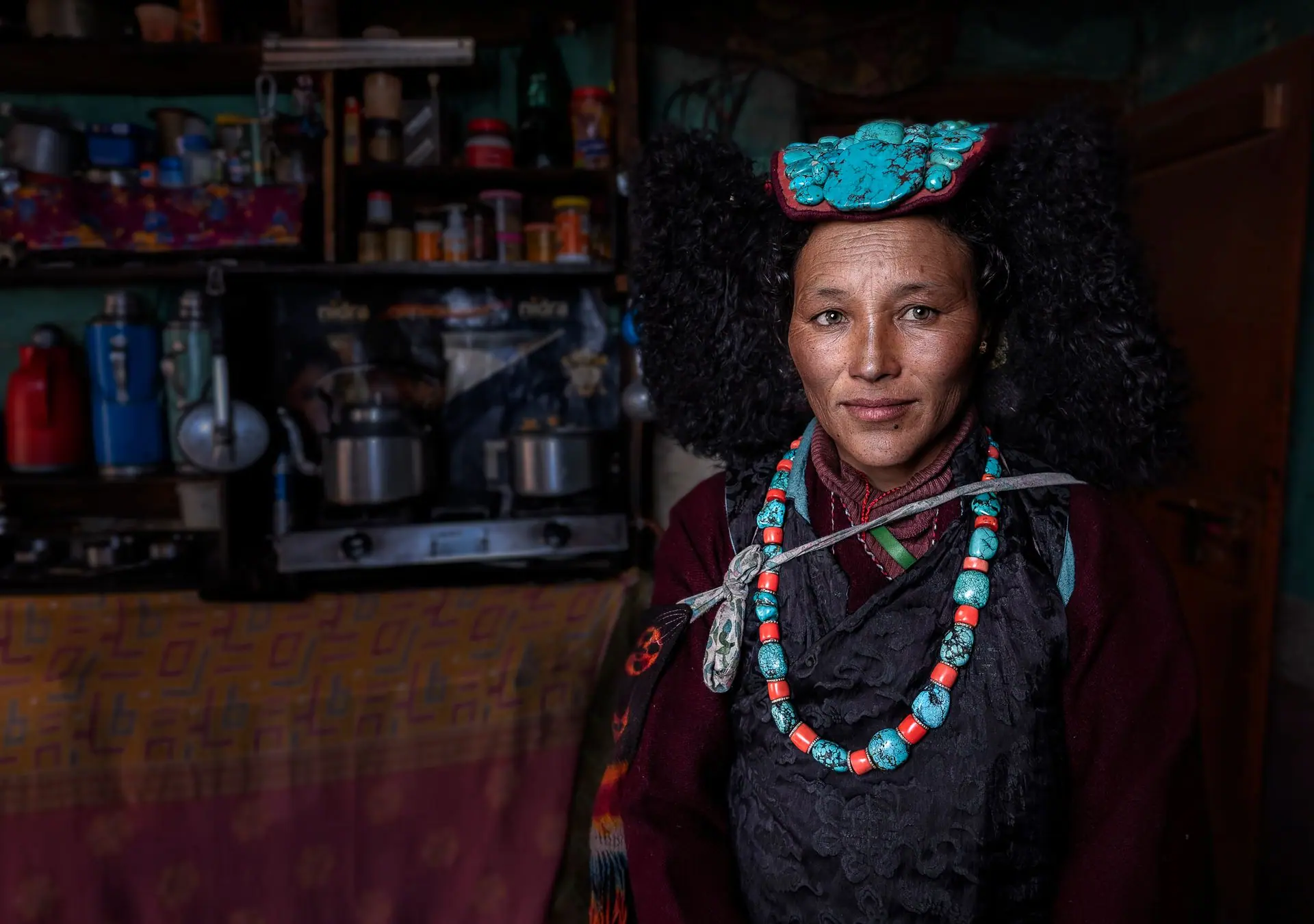 A captivating portrait of a middle-aged woman wearing traditional Ladakhi attire, showcasing cultural heritage