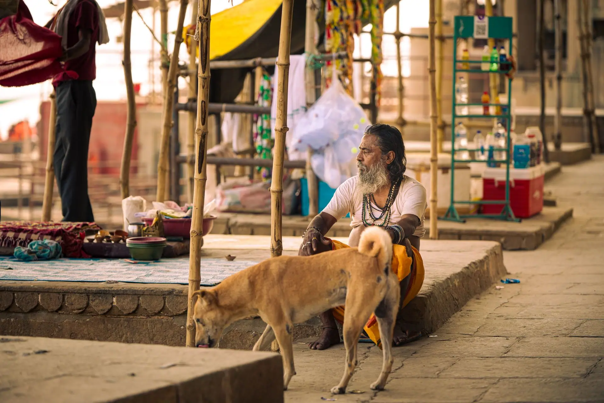 Portrait of an elderly man resting at the vibrant Varanasi ghats, adding to the city's cultural essence
