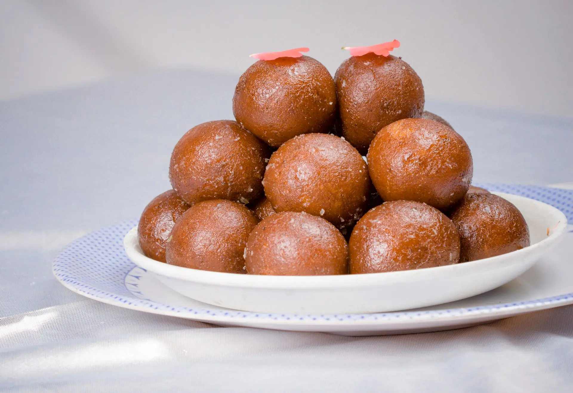 Close-up of a traditional Indian dessert, Gulab Jamun, served on a white plate