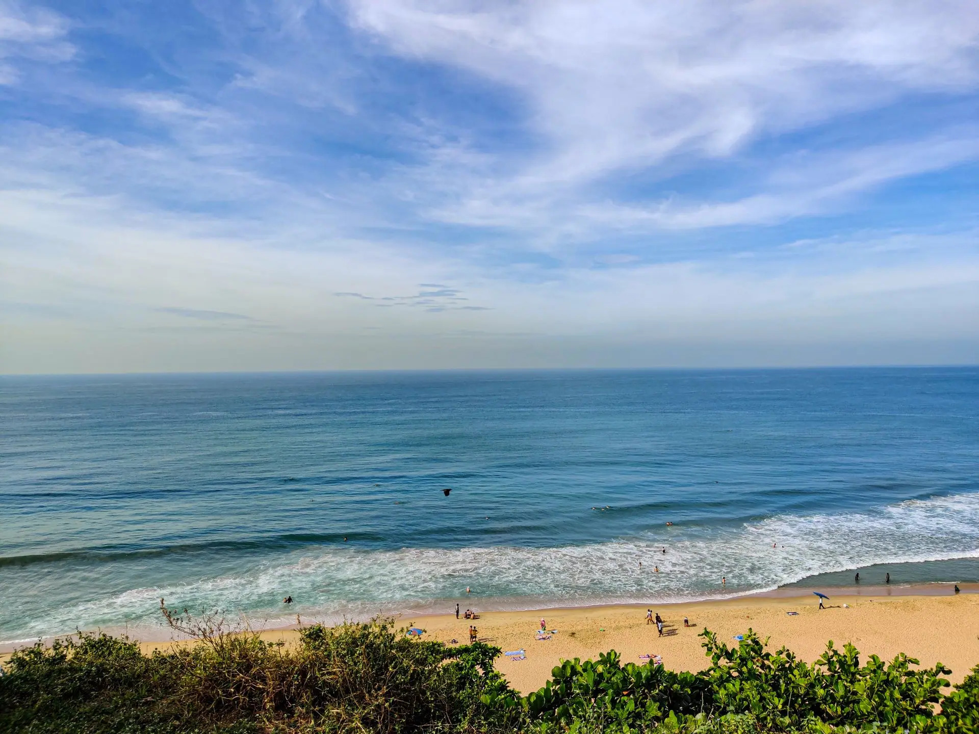 Beautiful sandy beach and turquoise waters in Varkala, Kerala, India, under a clear blue sky