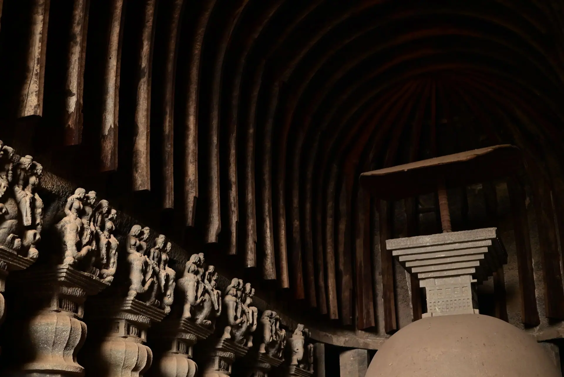 Explore the detailed carvings and stupa of a Buddhist rock-cut cave in Lonavala, India