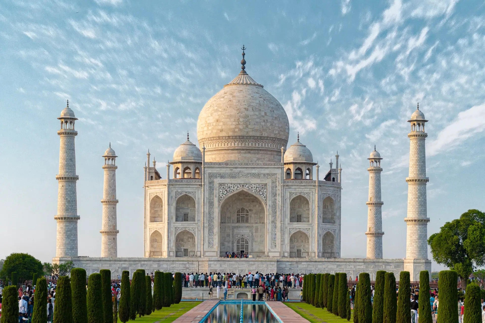 Explore the iconic Taj Mahal, a UNESCO World Heritage Site in Agra, India, captured under a bright blue sky