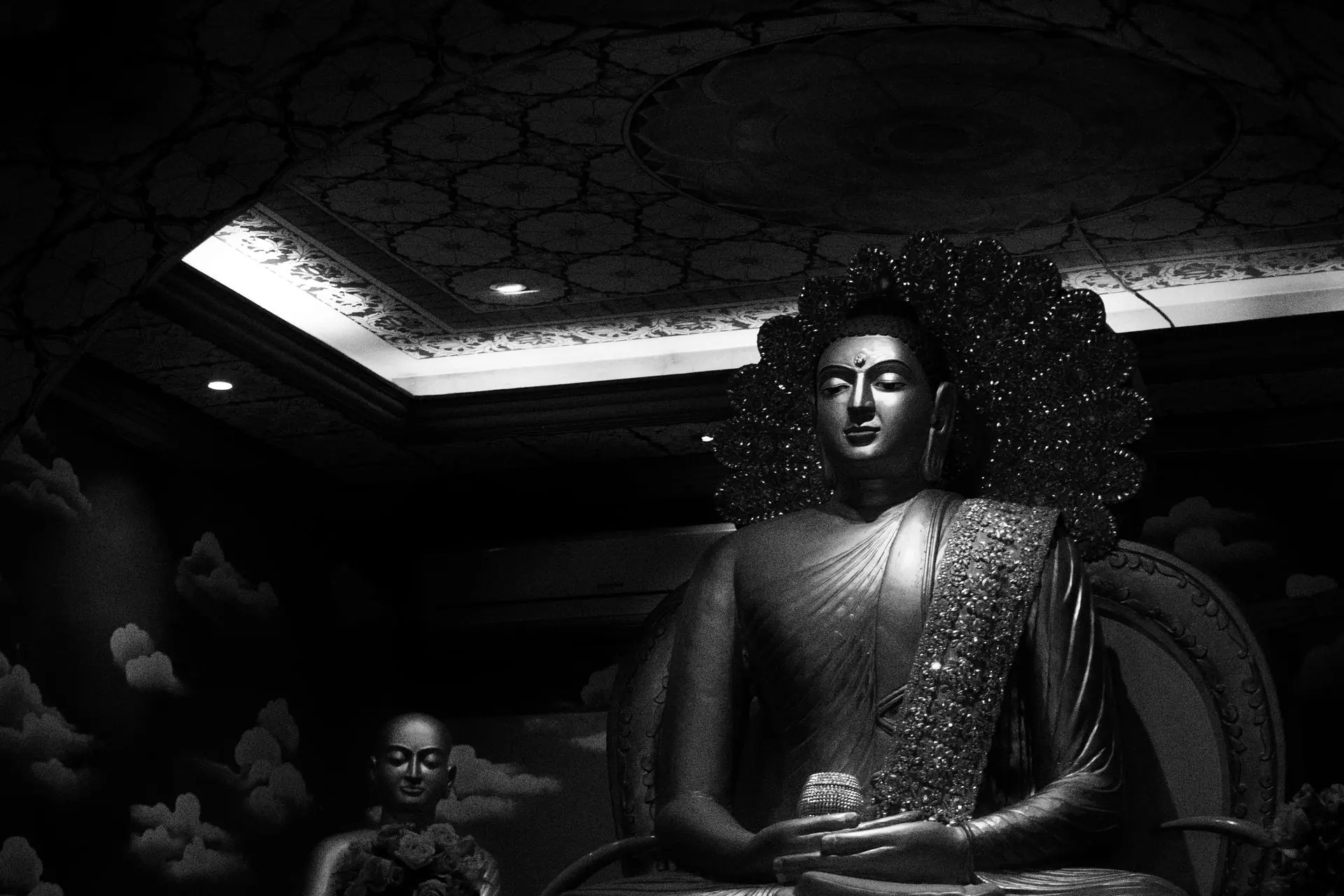 Striking black and white photo of a Buddha statue in Bodh Gaya, India, showcasing calmness and spirituality