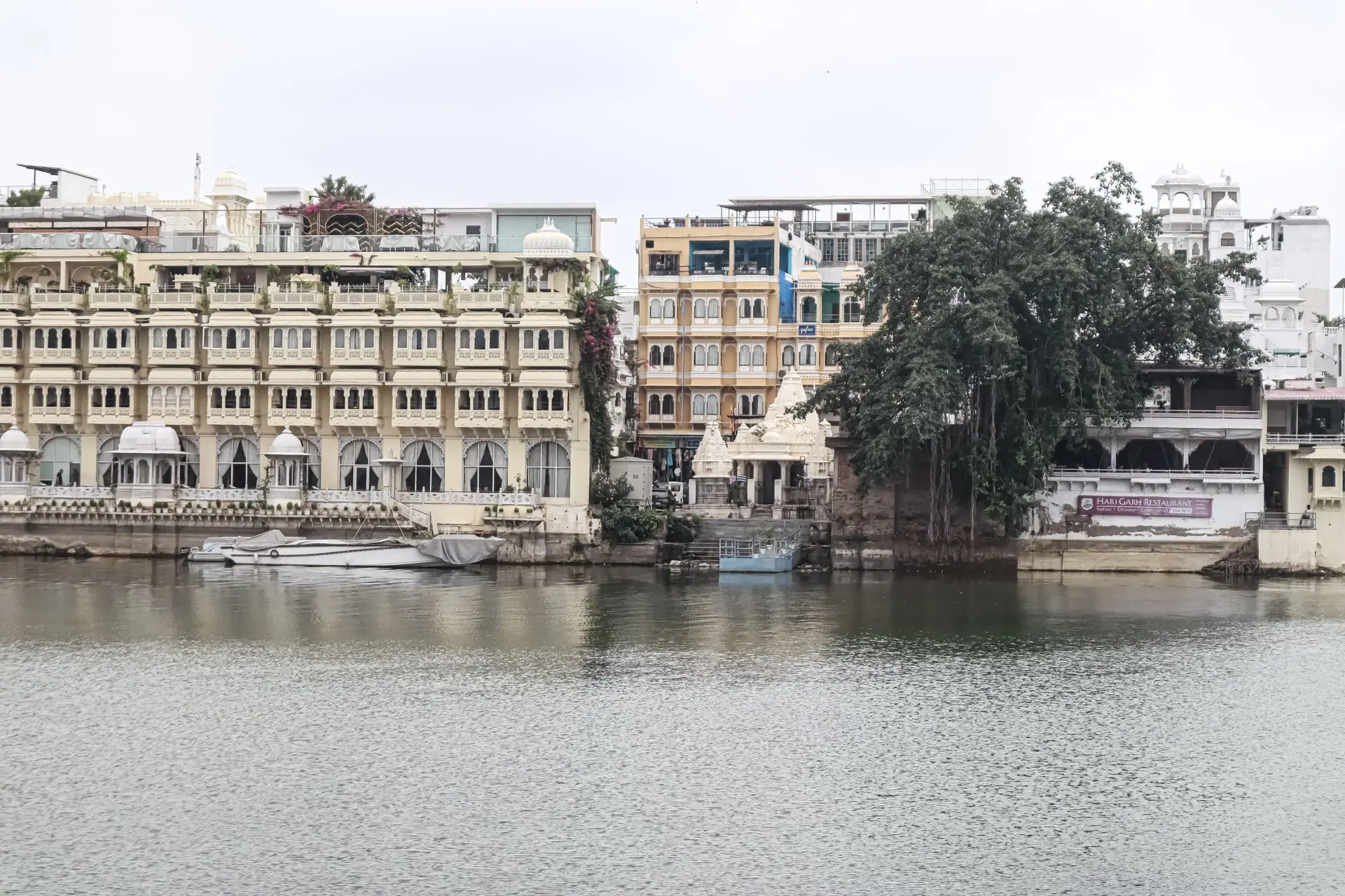 Picturesque view of Udaipur's historic lakeside architecture reflecting on calm waters