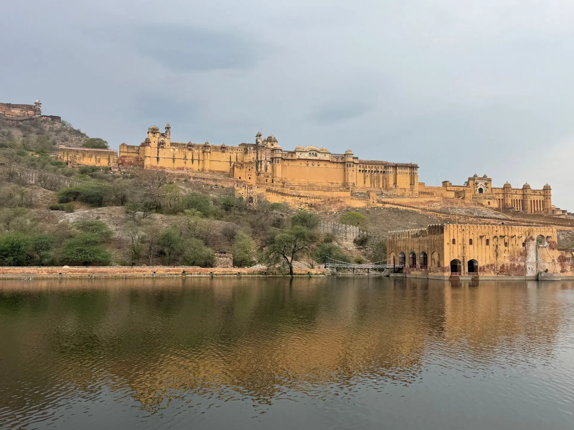 Stunning view of Amber Fort reflecting on the Maota Lake in Jaipur, showcasing historical architecture