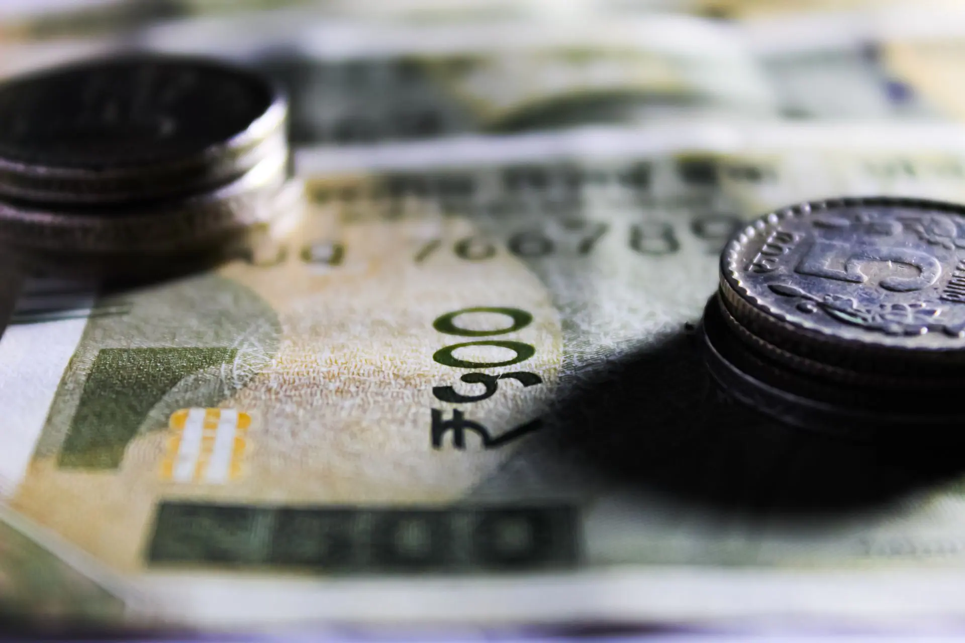 Detailed close-up of Indian rupee notes and coins showcasing currency design