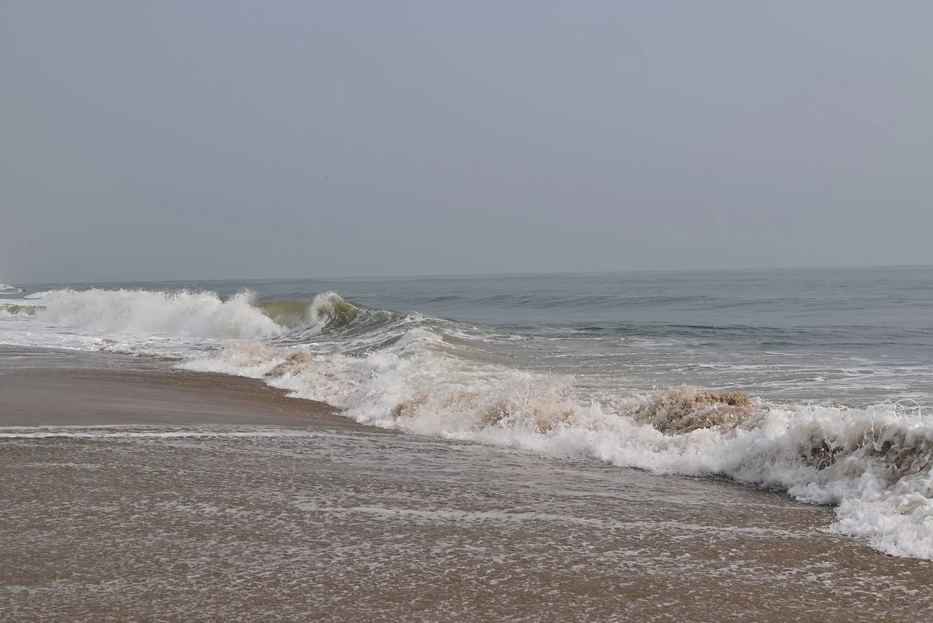 Tranquil ocean waves gently washing the sandy shores of Chennai