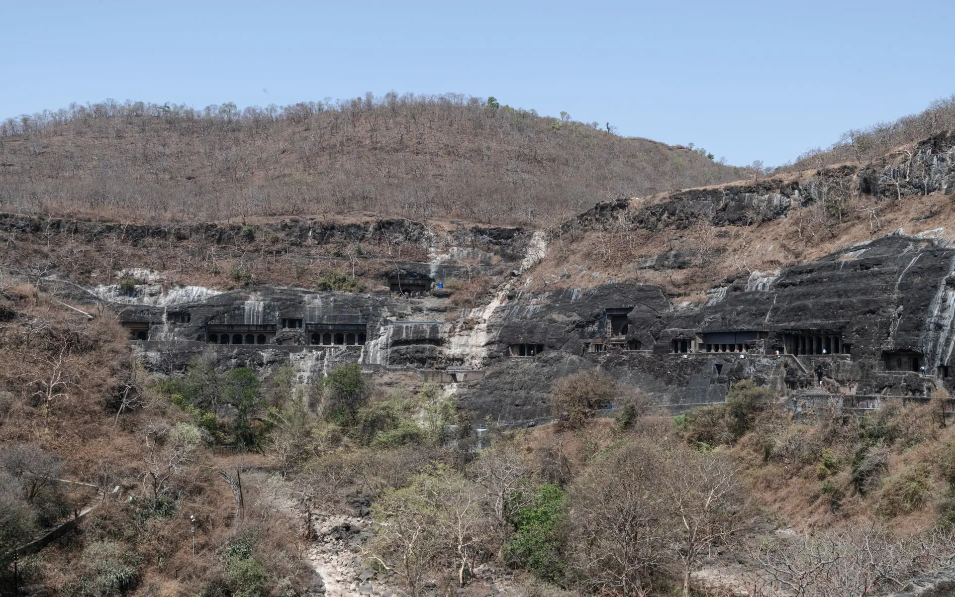 Explore the historic Ajanta Caves carved into a hillside in Maharashtra, India