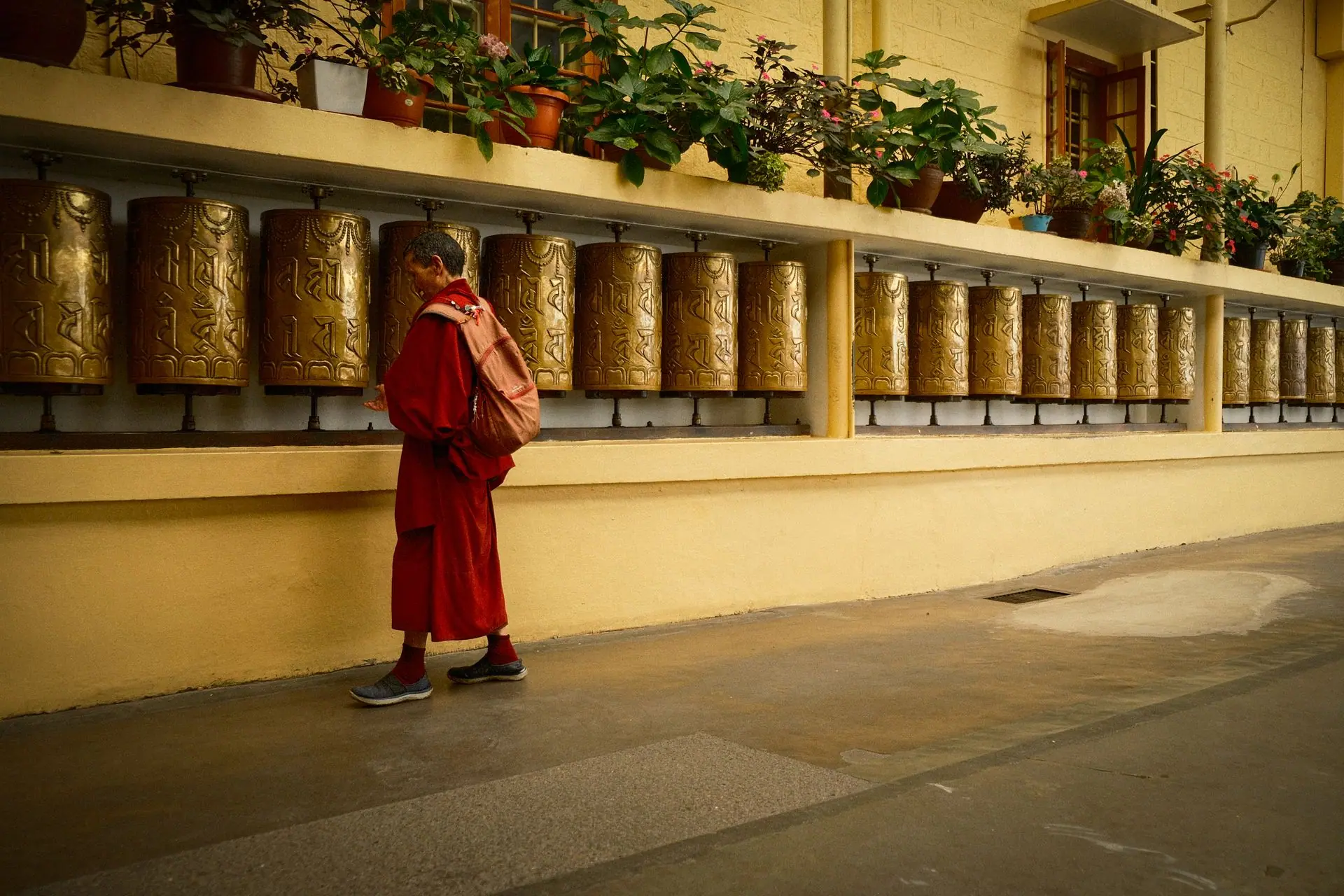 A Buddhist monk spins prayer wheels in a temple in Dharamshala, India