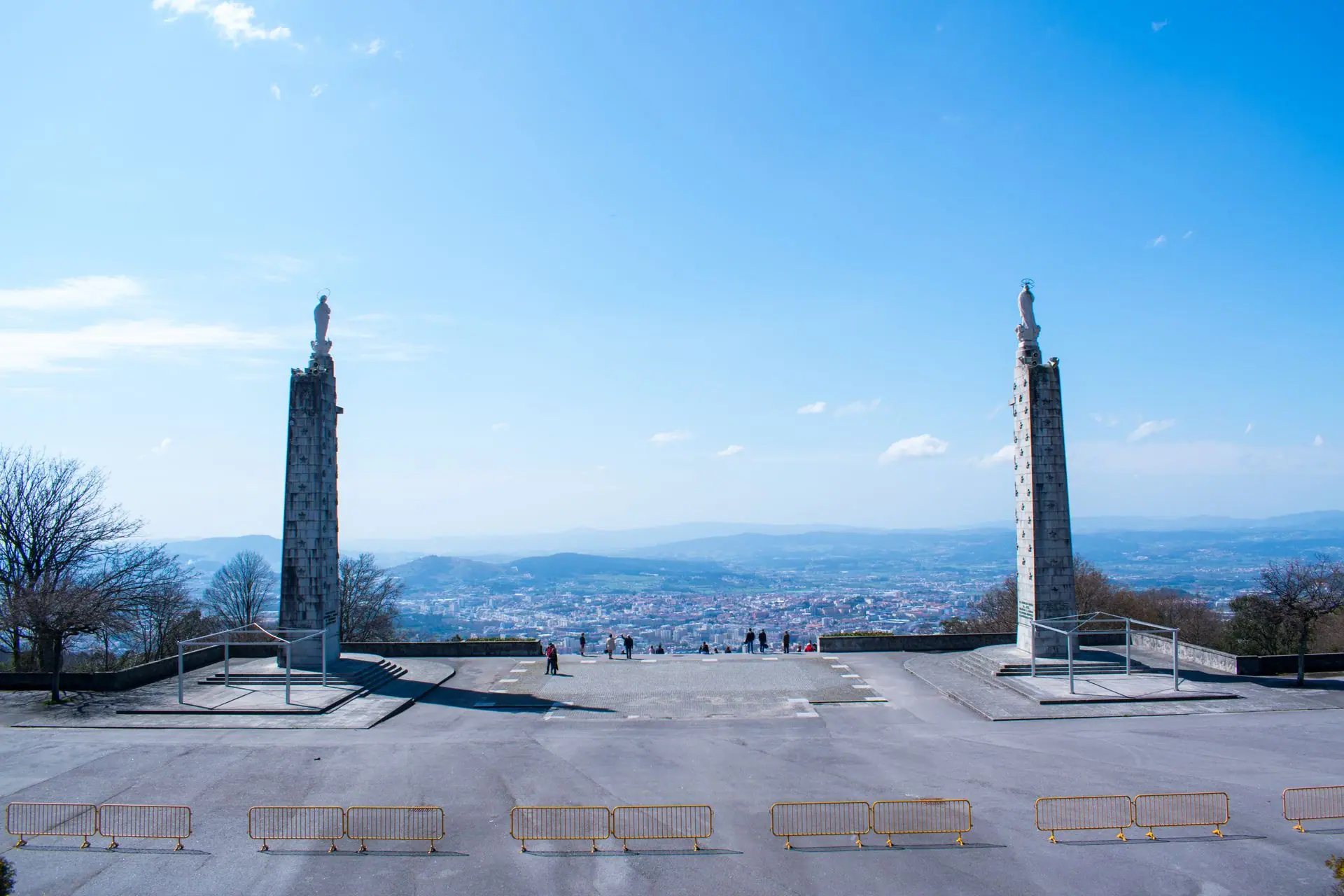 A clear view from Bom Jesus, Azores, capturing architectural columns and a distant cityscape under a blue sky