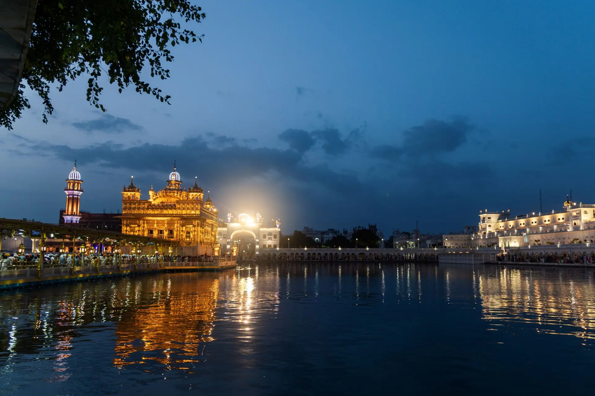 Stunning view of the Golden Temple in Amritsar reflecting in water at twilight, showcasing Sikh architecture