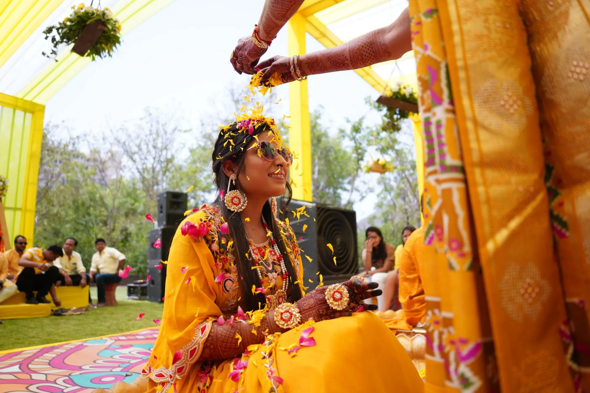 Joyful moments from a traditional Indian Haldi ceremony with vibrant yellow decor and festivities