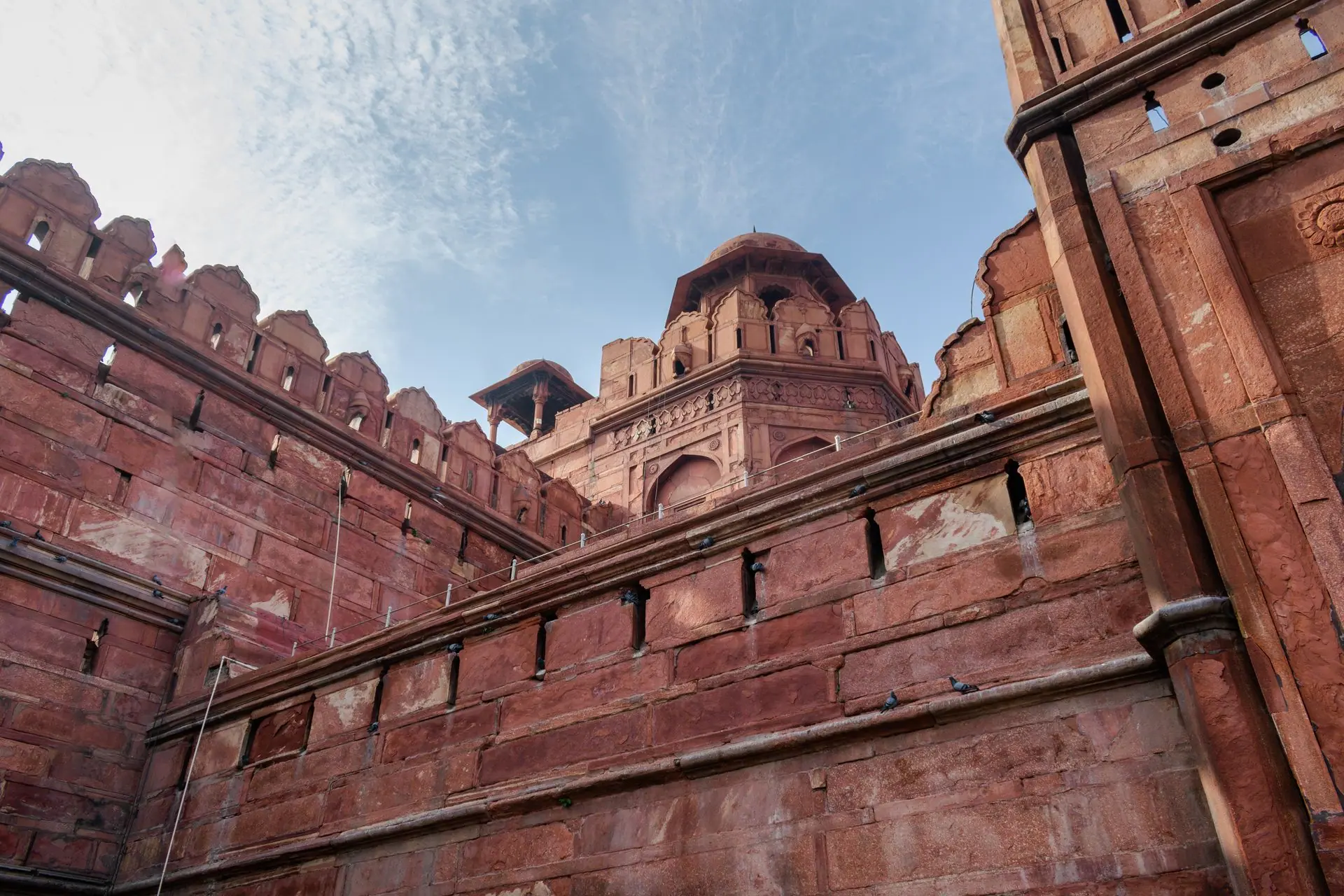 An impressive low-angle view of the Red Fort's historic Mughal architecture in Delhi, India