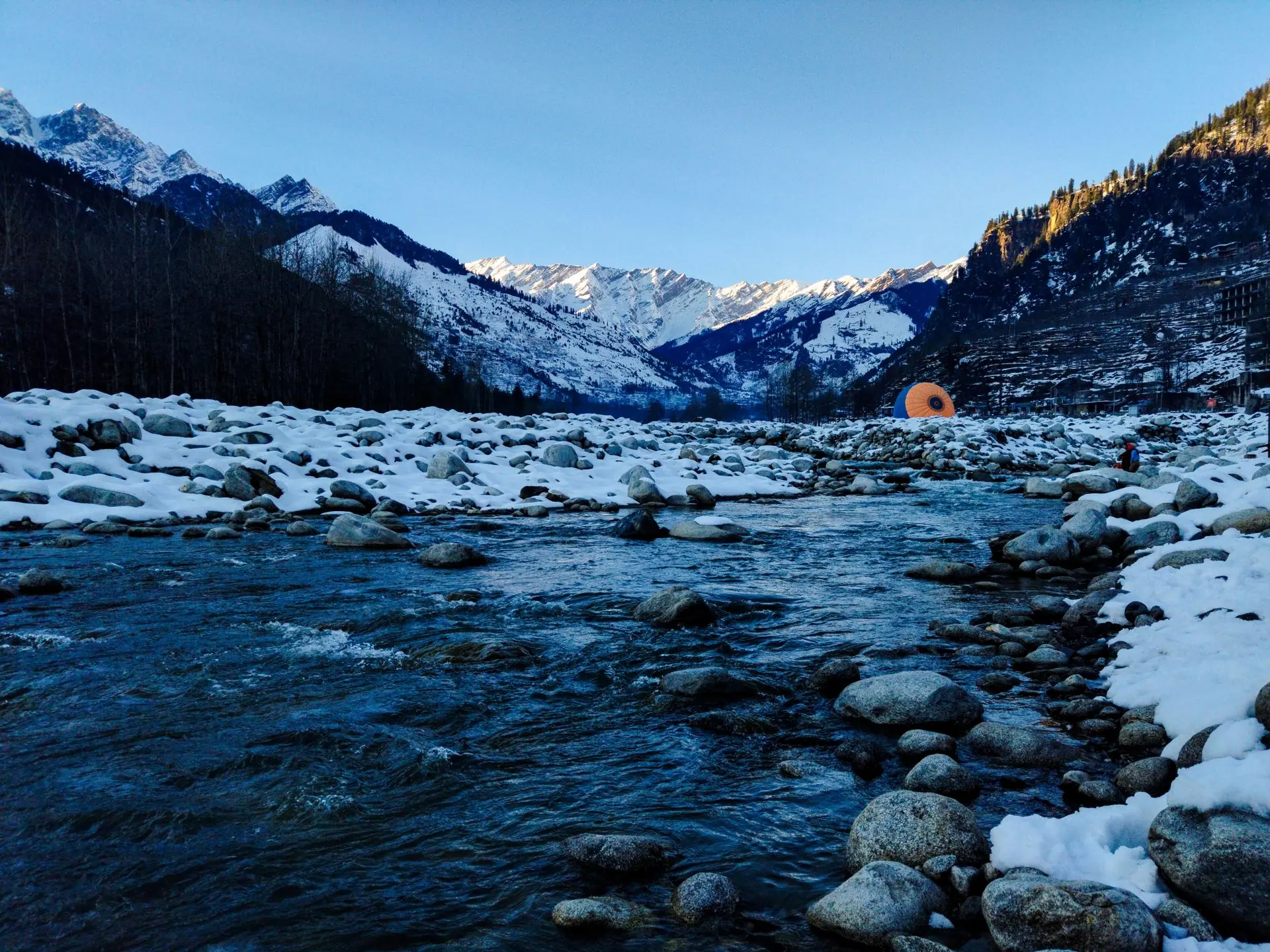 Beautiful snow-covered valley and river in Manali, India capturing the serene winter landscape