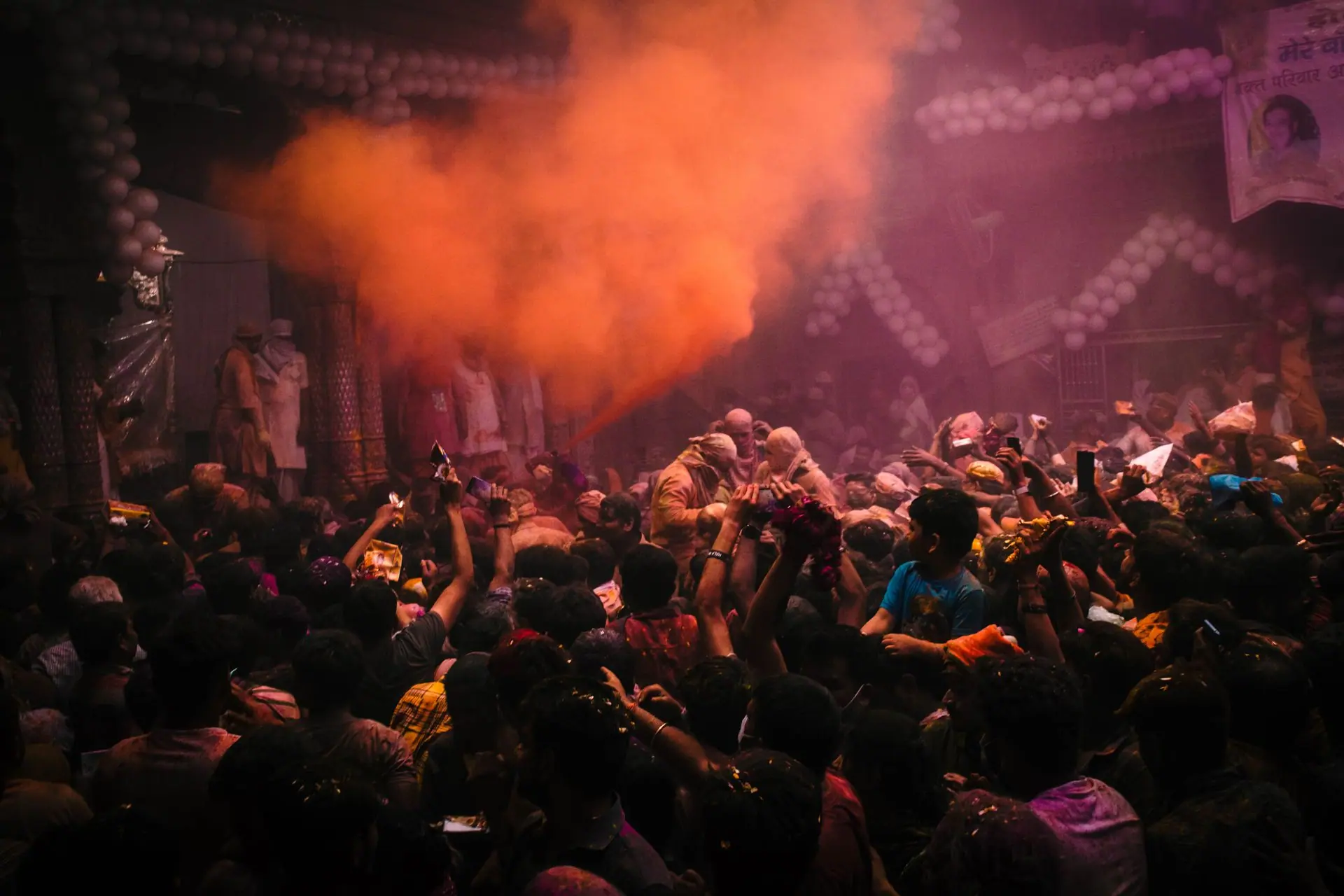 Vibrant Holi celebration in Vrindavan, India, with colorful powders and lively crowd