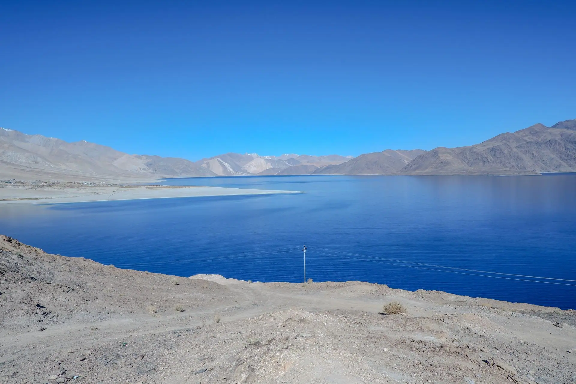 Captivating view of Pangong Lake with clear blue skies and mountain backdrop