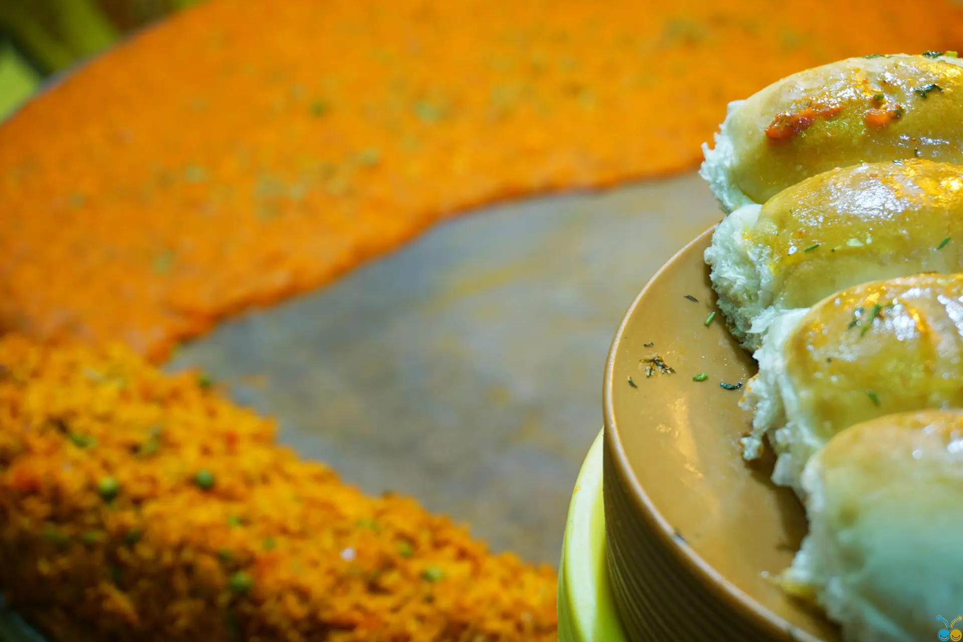Fresh bread rolls with Indian pav bhaji curry, perfect for a flavorful meal