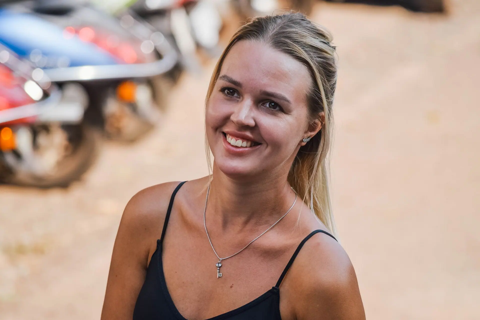 A smiling woman enjoying an outdoor setting in Panaji, Goa, India