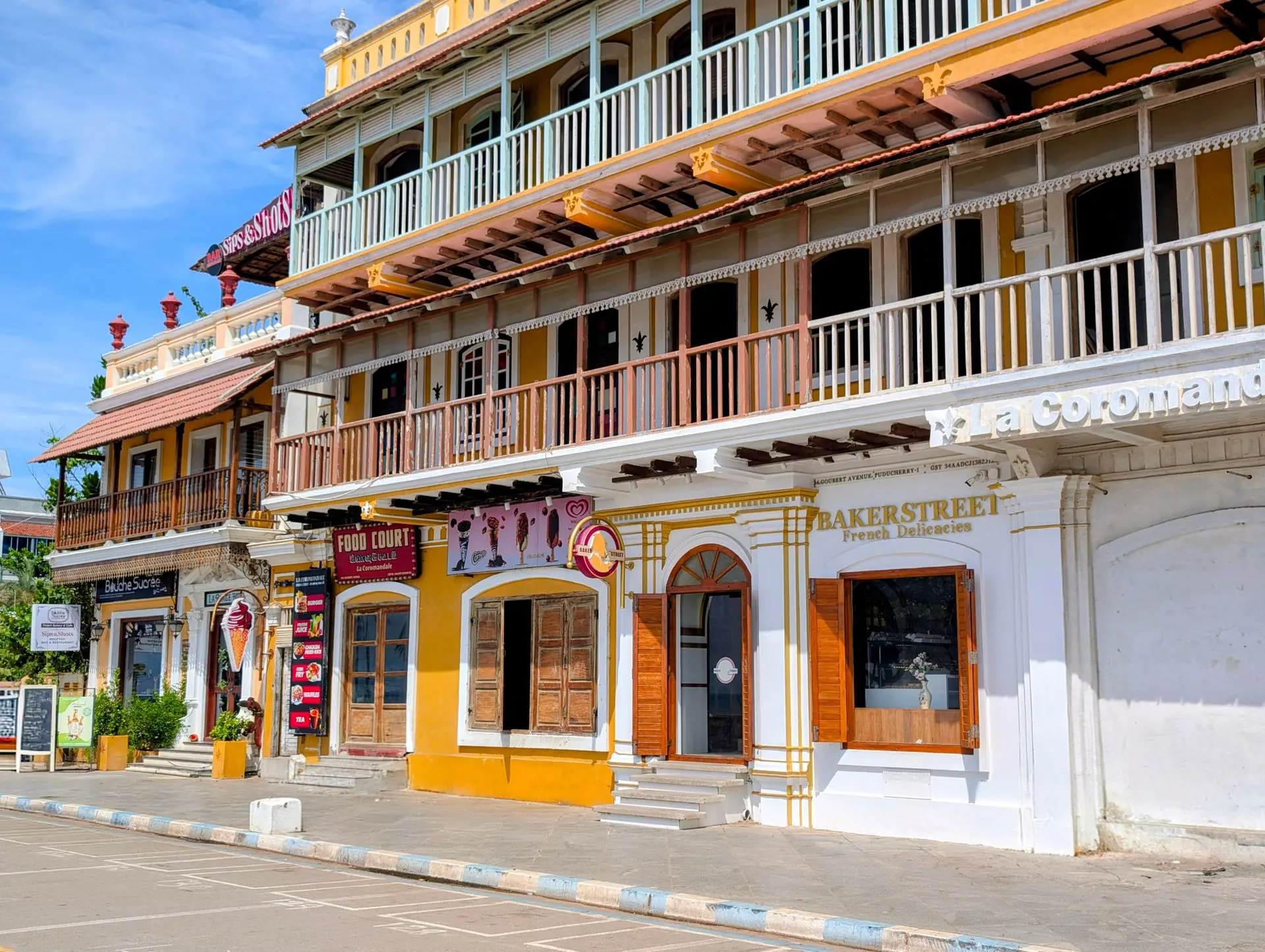 Colorful colonial buildings line the streets of vibrant Puducherry, showcasing historic architecture