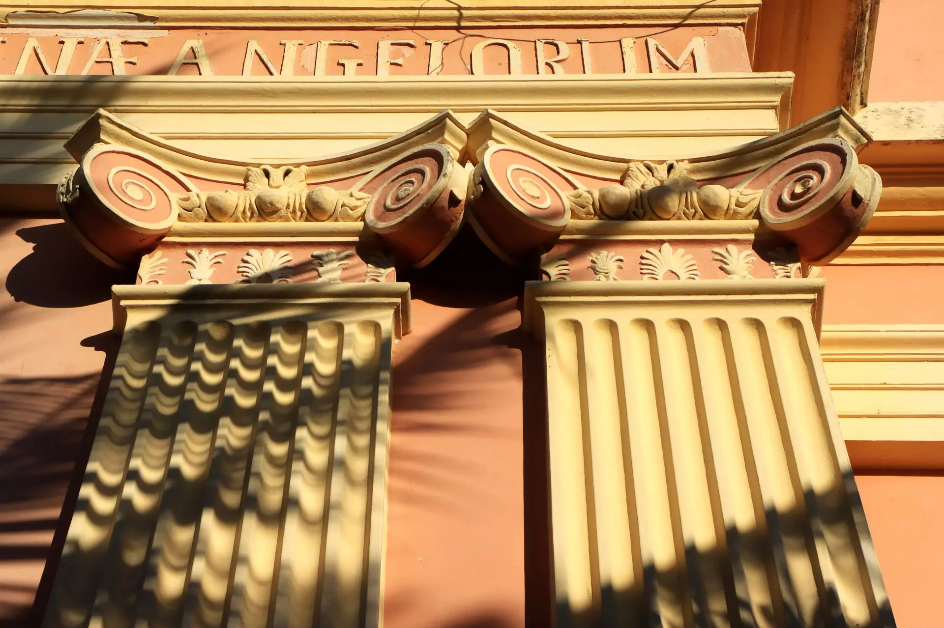 Baroque architectural detail of columns captured in warm sunlight in Puducherry, India