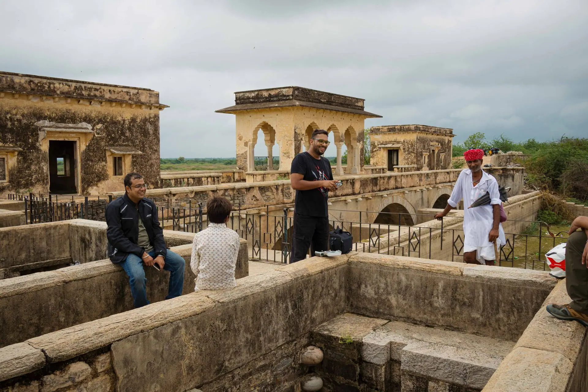 Tourists engaging with a local guide at an ancient site in Jaipur, Rajasthan