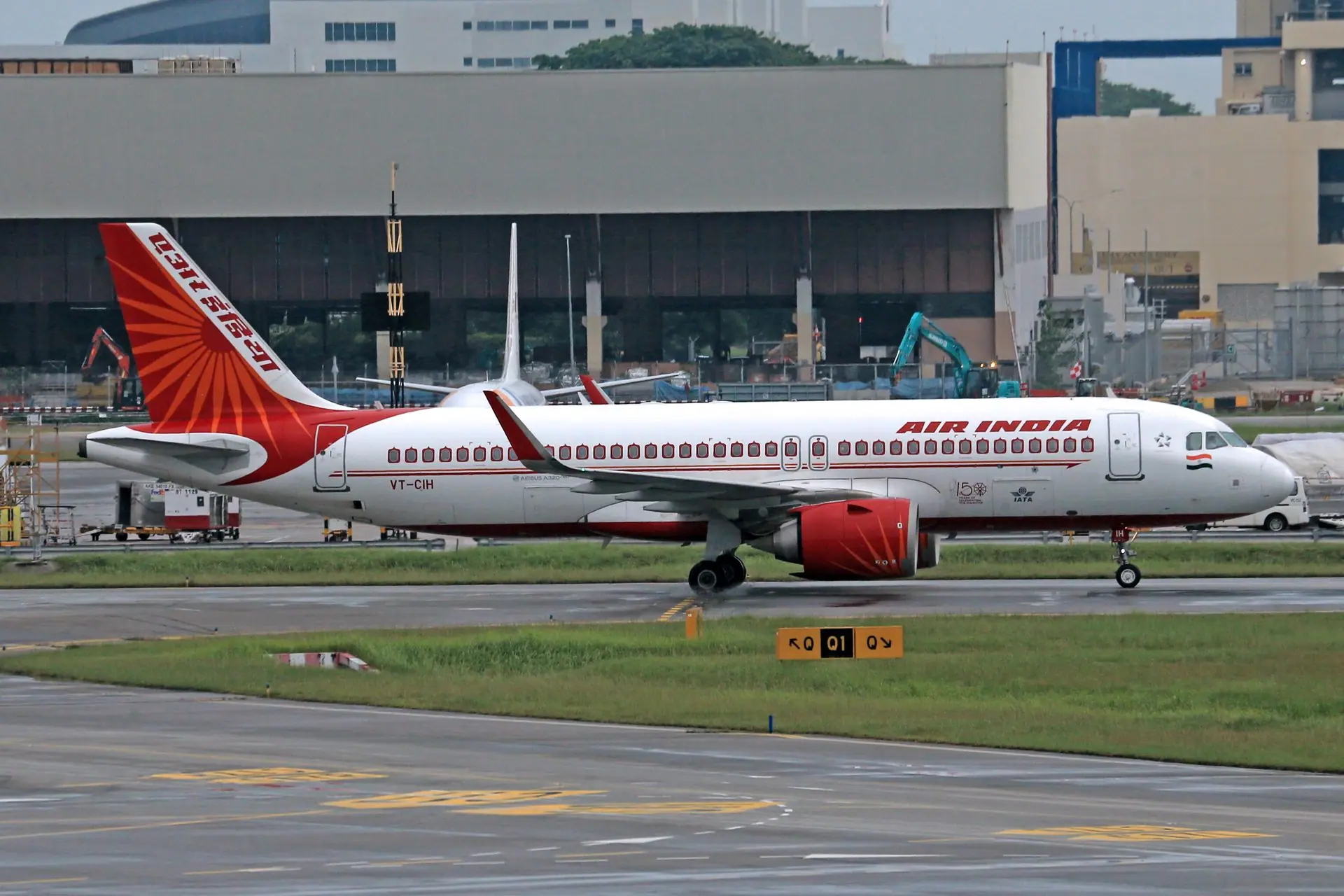 Air India Airbus A320 parked on runway at an airport, ready for departure