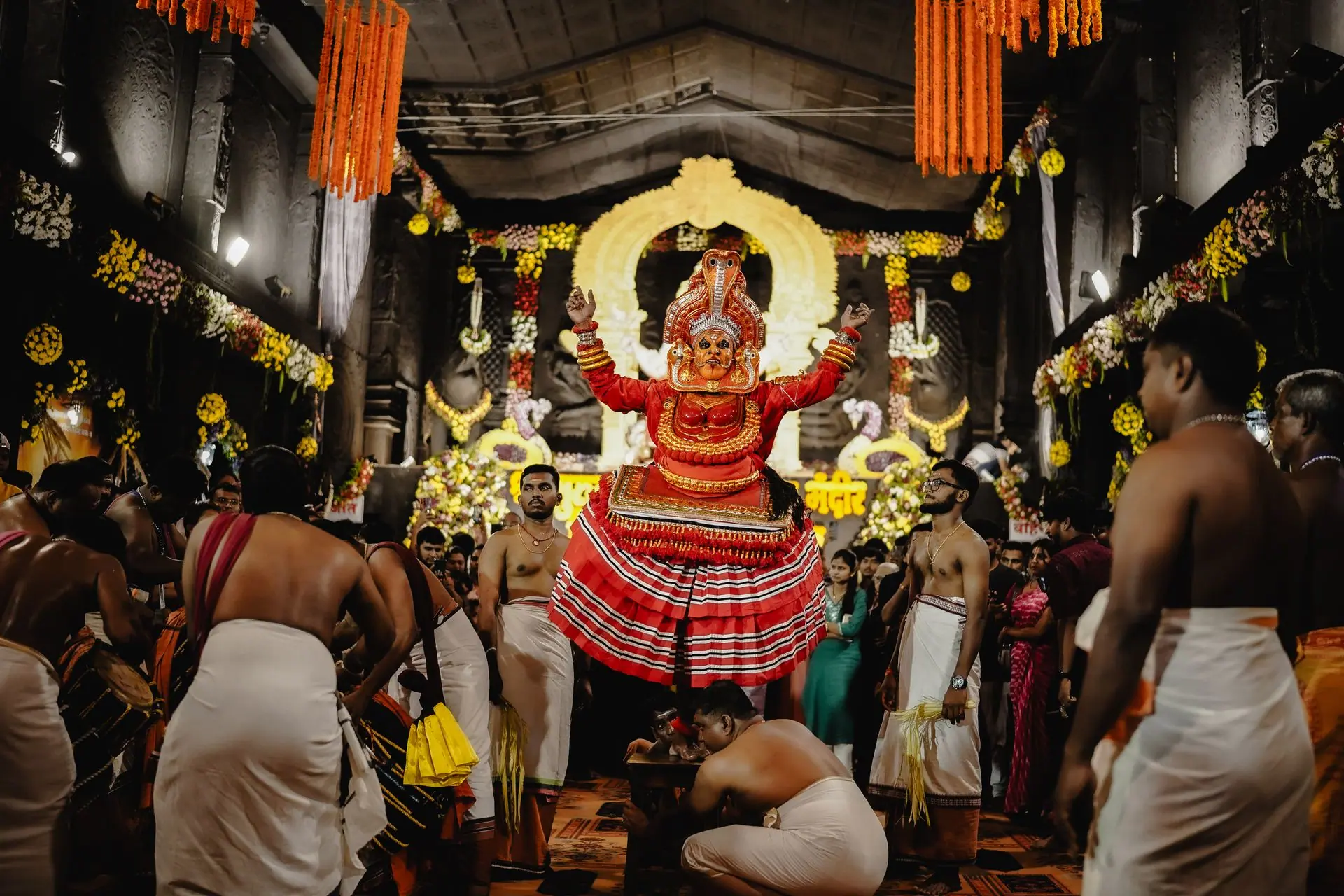 A vibrant Theyyam performance inside a decorated temple in Nagpur, Maharashtra, India
