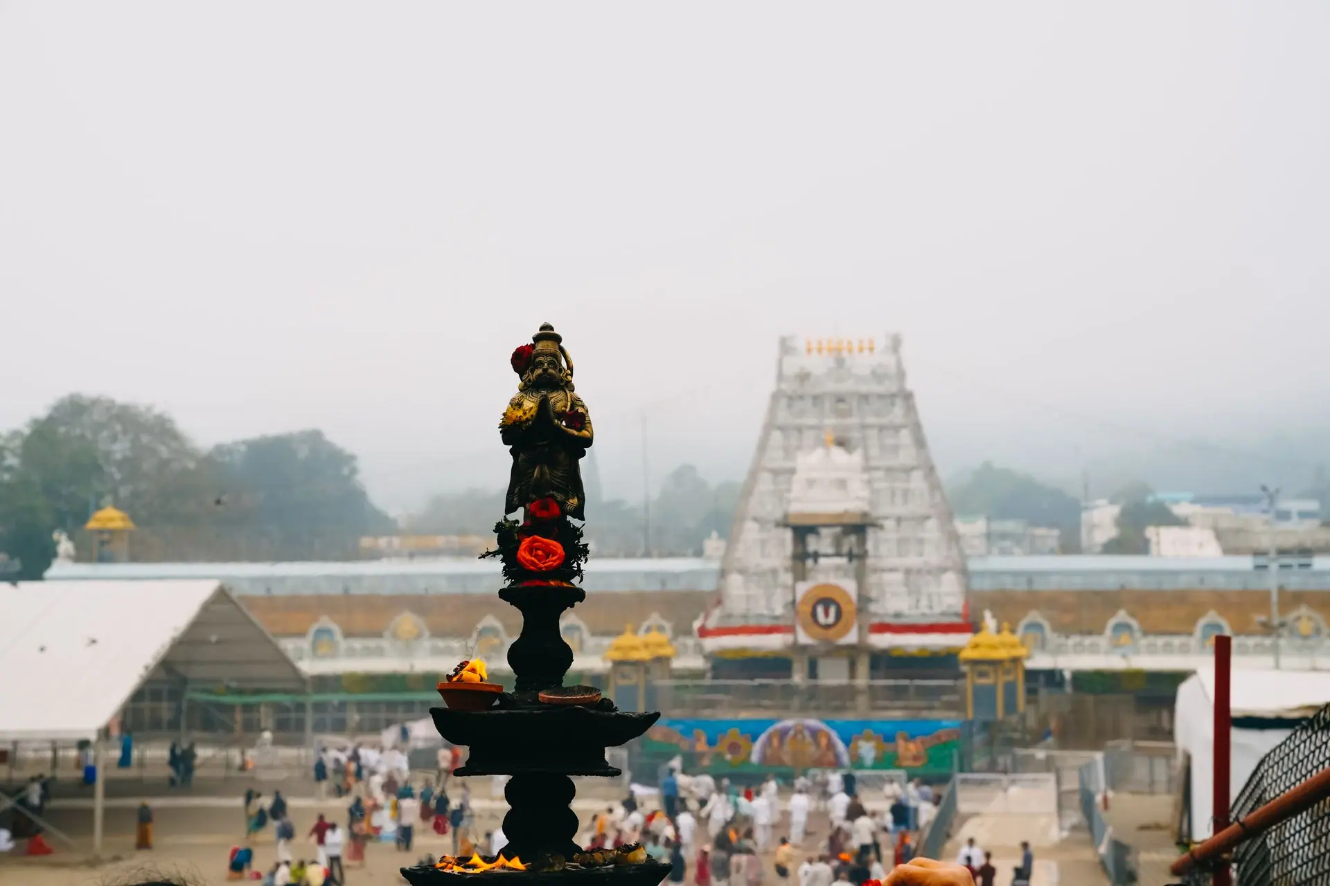 View of Tirupati Temple with a traditional oil lamp in the foreground, capturing the essence of Indian spirituality