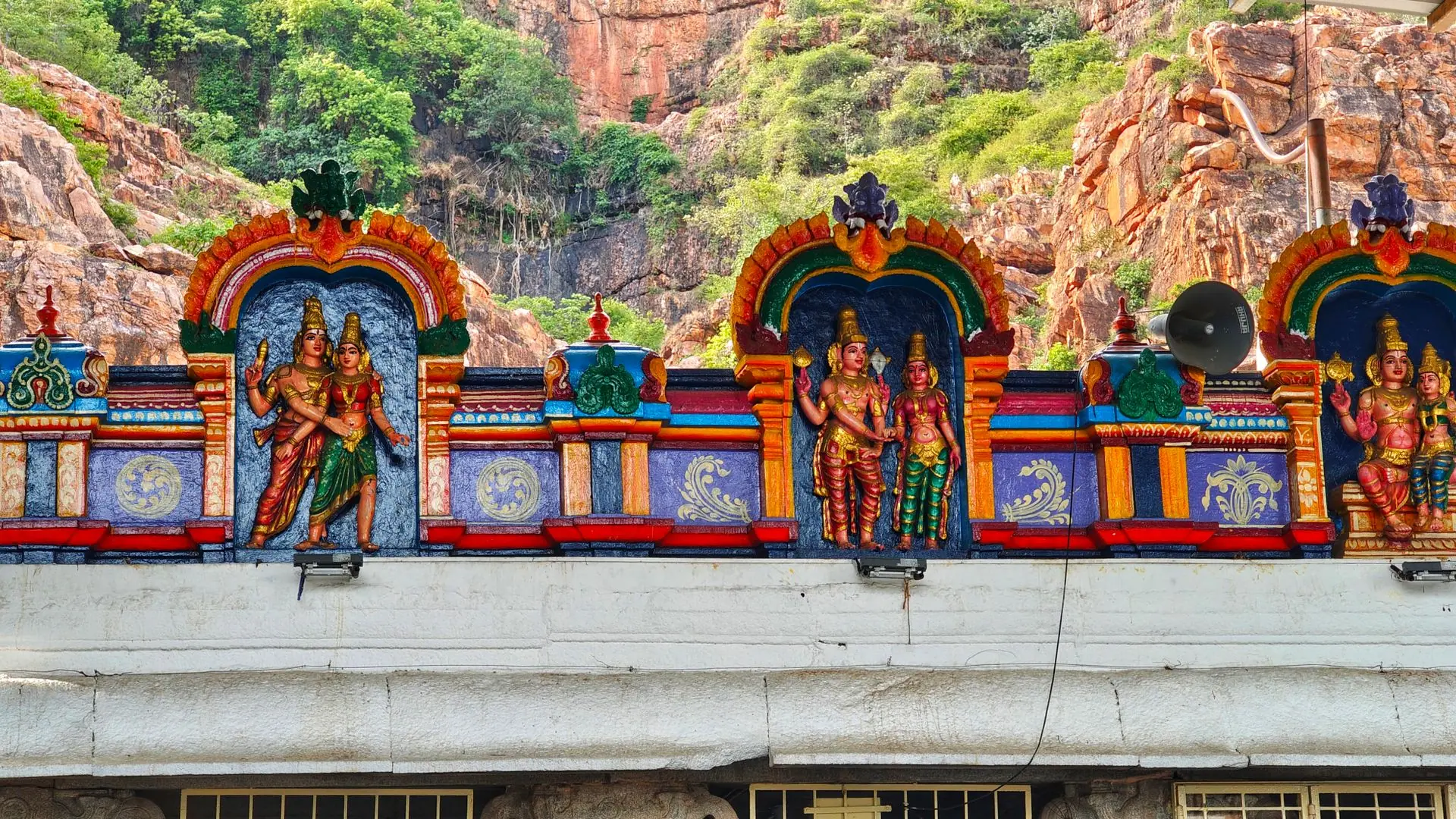 Colorful sculptures on a Hindu temple facade in Tirupati, India, showcasing intricate craftsmanship and religious symbolism
