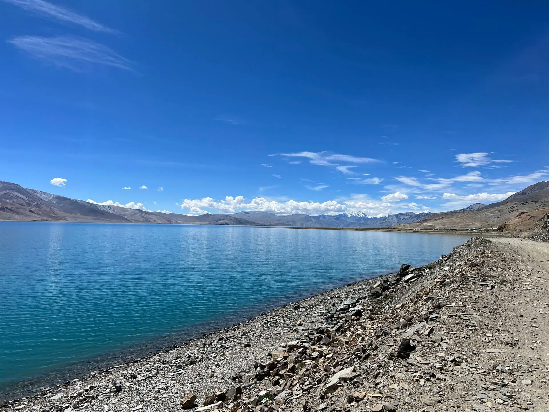 Beautiful landscape of Tso Moriri Lake with clear blue skies and rugged mountain backdrop in Ladakh